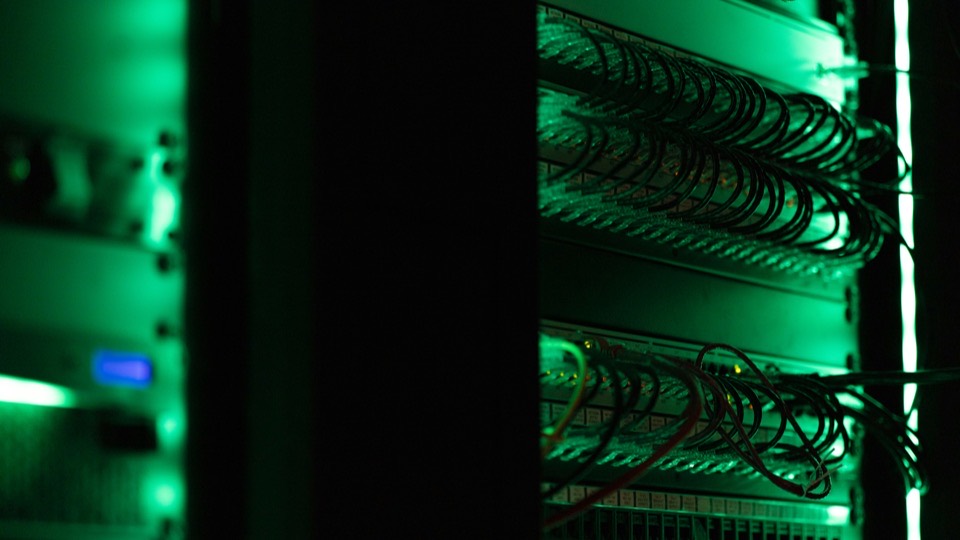Server rack with network cables lit in green, the systems an MCP server sits in front of